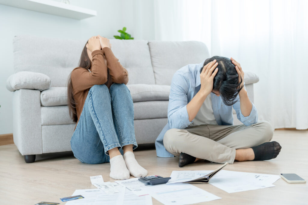couple stressed out about selling home due to foreclosure and high. bills