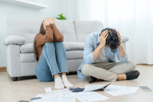 couple stressed out about selling home due to foreclosure and high. bills